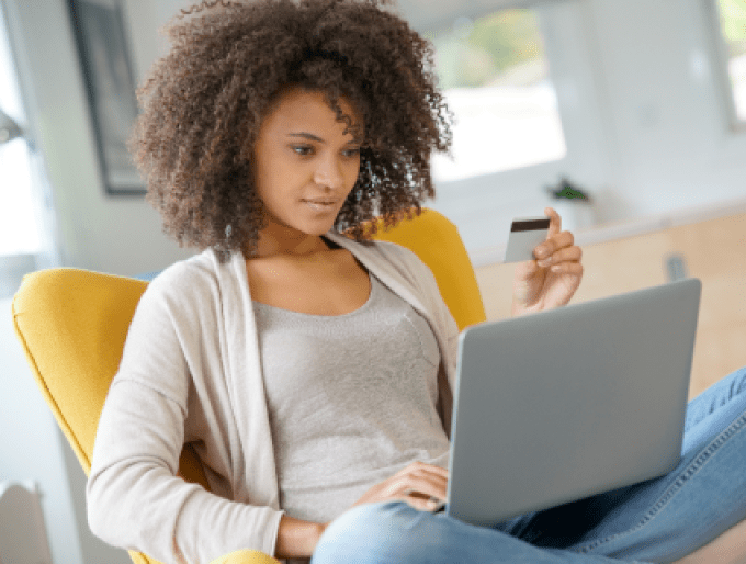 Women looking at laptop and holding a credit card
